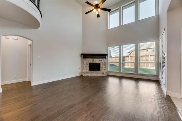 a view of a livingroom with wooden floor and a fireplace
