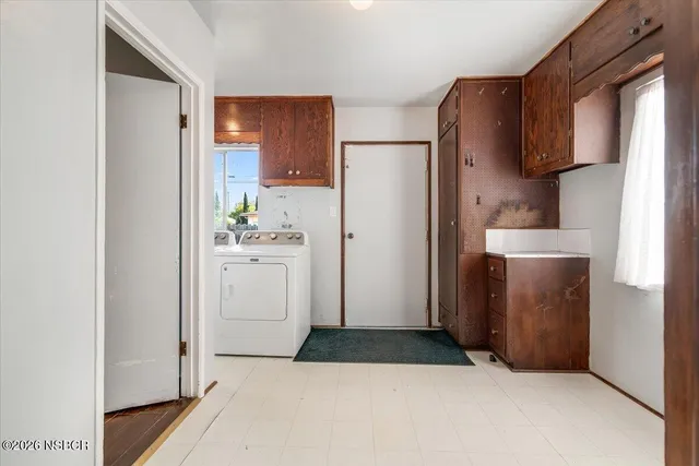 a kitchen with a refrigerator sink and cabinets