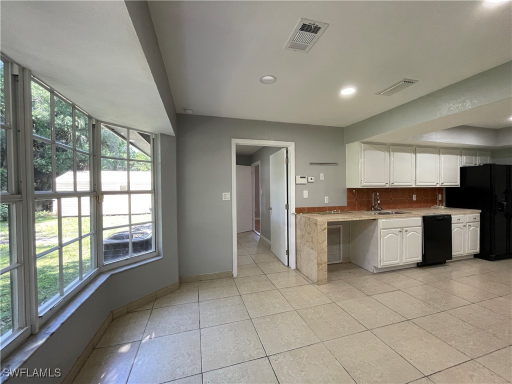 200 Ridgewood Avenue Clewiston, FL 33440 - Photo 25 of 50 a large kitchen with a stove a sink and a refrigerator