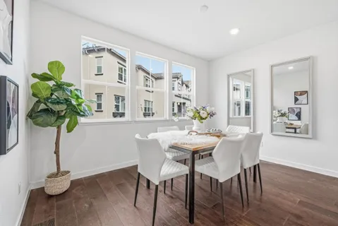 a view of a dining room with furniture and wooden floor