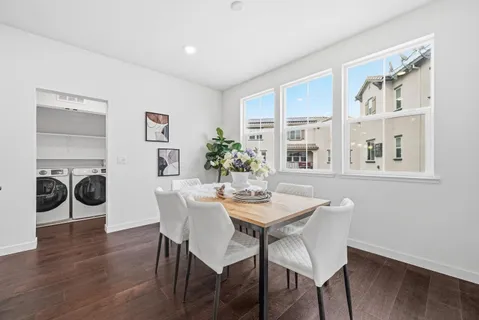 a dining room with furniture and wooden floor