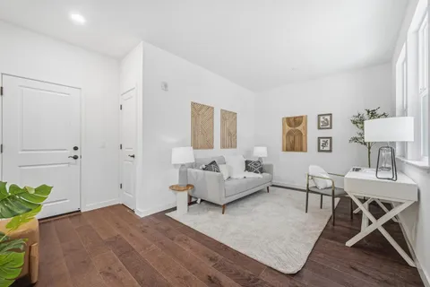 a bedroom with furniture and a wooden floor