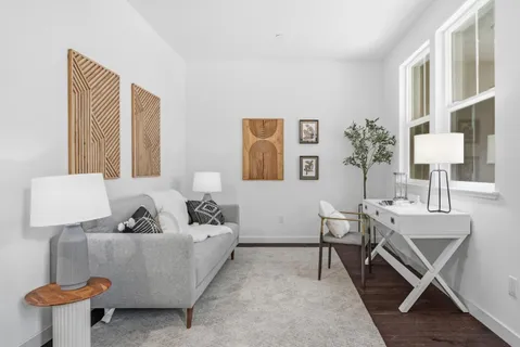 a living room with furniture and a potted plant
