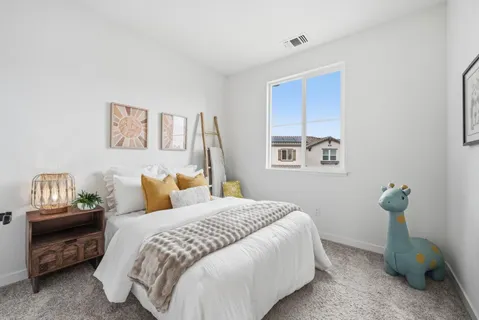 a bedroom with a bed and a night stand