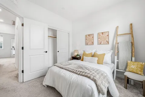 a bedroom with a bed and a painting on the wall