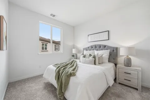 a bedroom with a bed and a night stand