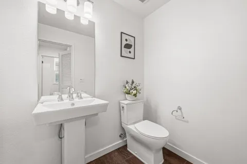 a bathroom with a sink mirror and toilet