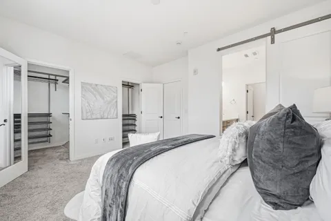 a bed room with a bed and cabinets