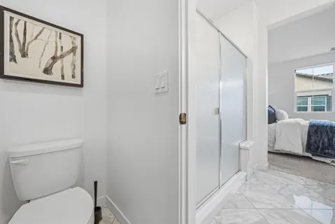a bathroom with a toilet sink and shower