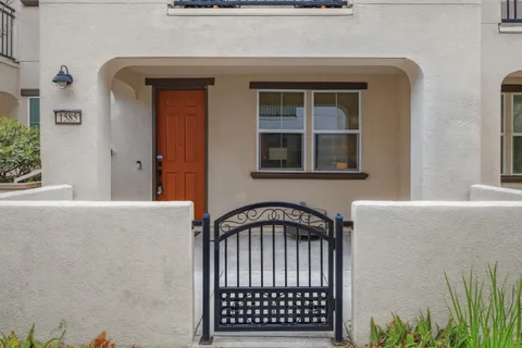 a backyard of a house with barbeque oven and glass door