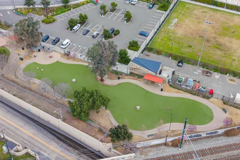 a backyard of a house with barbeque oven and glass door