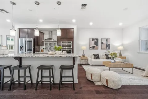 a large kitchen with a table and chairs