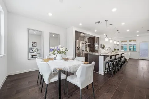 a view of a dining room with furniture and wooden floor