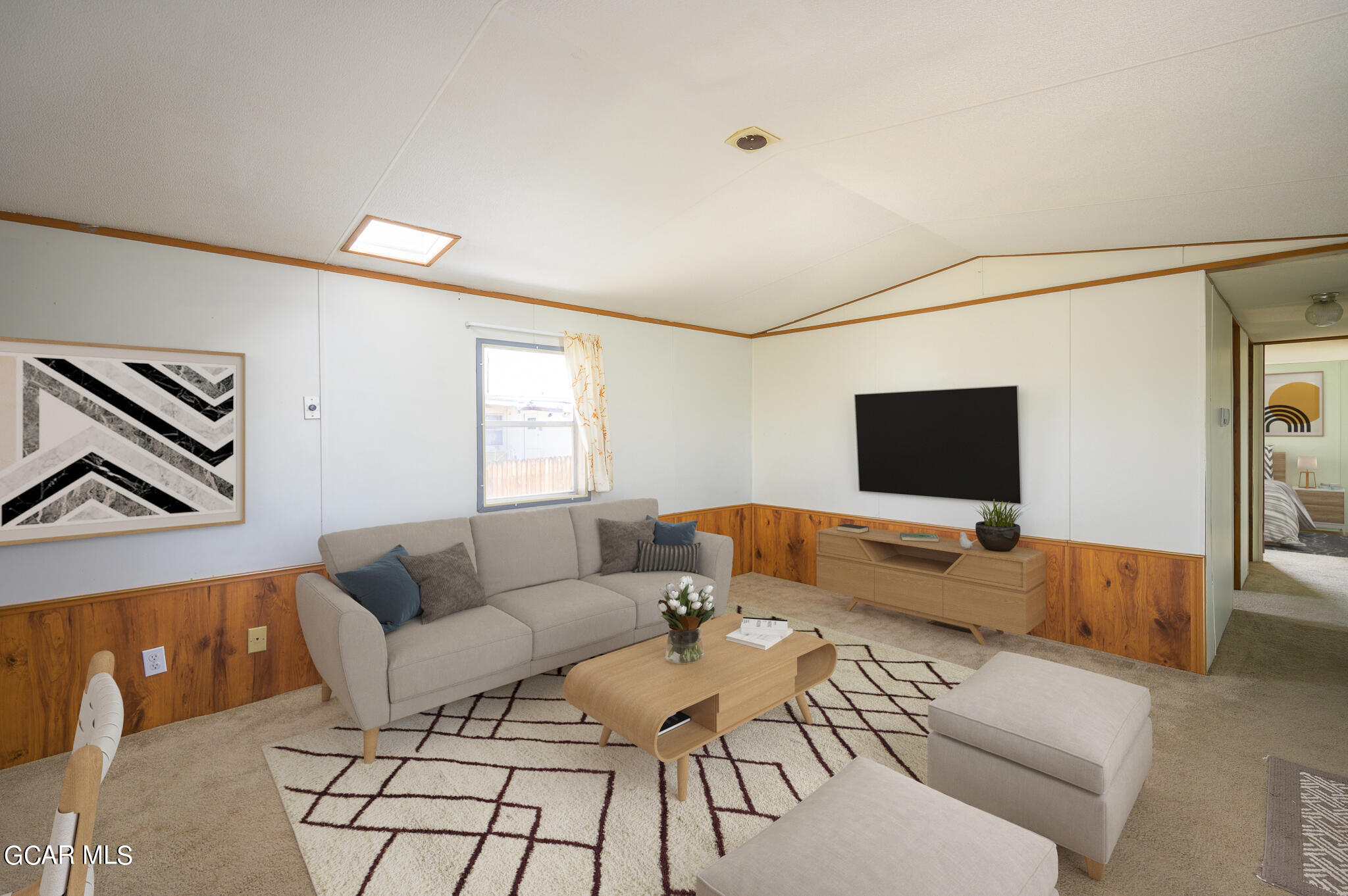 a living room with furniture and a flat screen tv