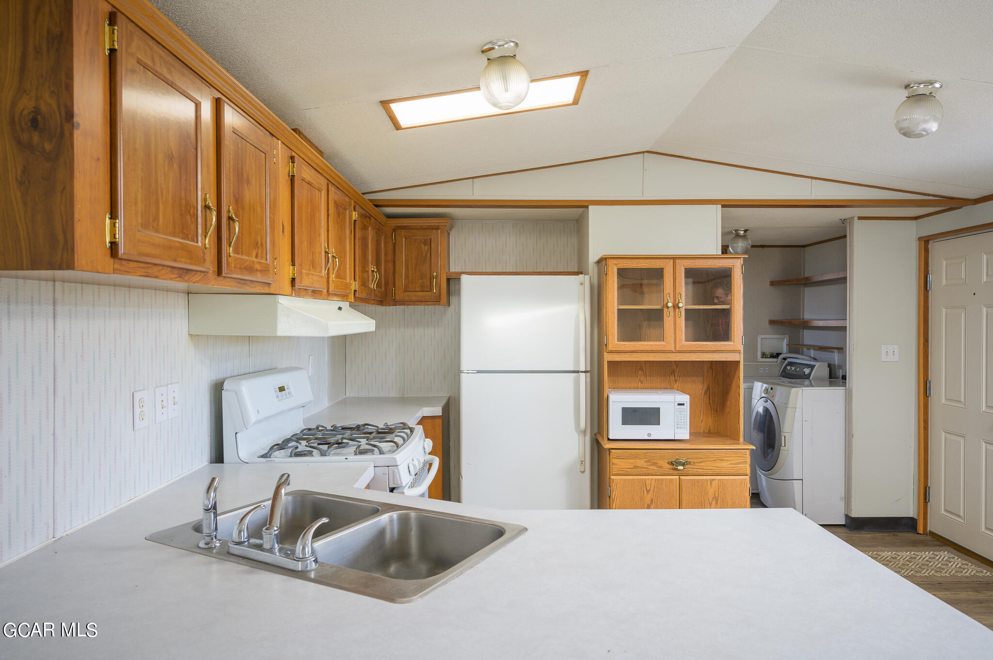 430 Casa Drive Granby, CO 80446 - Photo 15 of 37 a kitchen with a sink and refrigerator