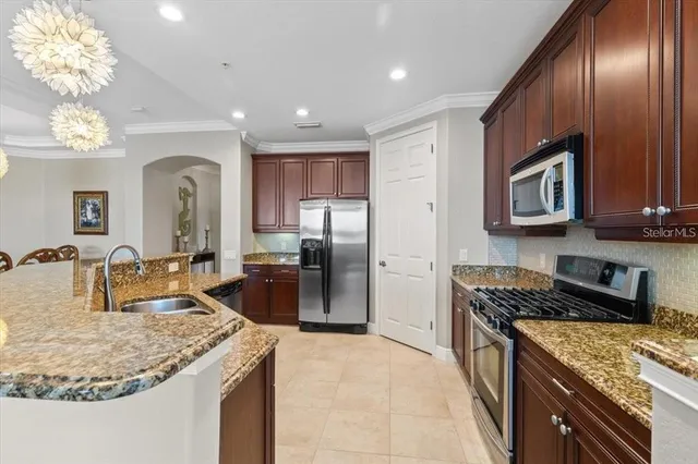 a kitchen with granite countertop stainless steel appliances and wooden cabinets
