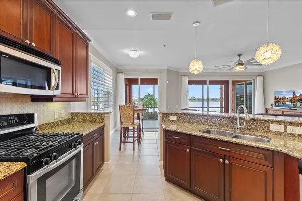 a kitchen with a stove a sink and a microwave