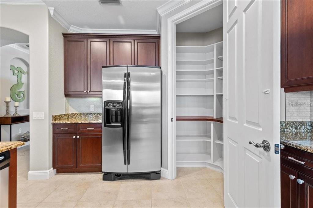 1143 Riverscape Street, Unit A Bradenton, FL 34208 - Photo 15 of 53 a kitchen with stainless steel appliances cabinets and a refrigerator