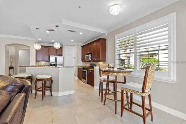 a view of kitchen with granite countertop cabinets table and chairs