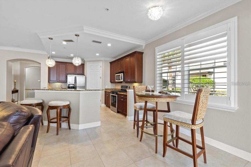 1143 Riverscape Street, Unit A Bradenton, FL 34208 - Photo 17 of 53 a view of kitchen with granite countertop cabinets table and chairs