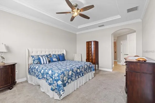 a bedroom with a bed and a chandelier