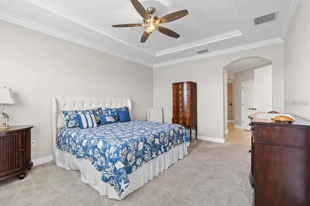 a bedroom with a bed and a chandelier