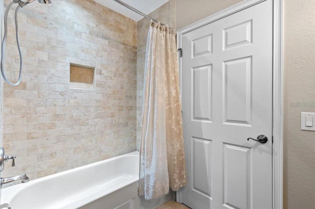 1143 Riverscape Street, Unit A Bradenton, FL 34208 - Photo 38 of 53 a bathroom with a bathtub and a shower