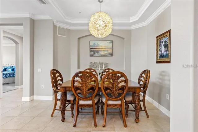 a view of a dining room with furniture and chandelier