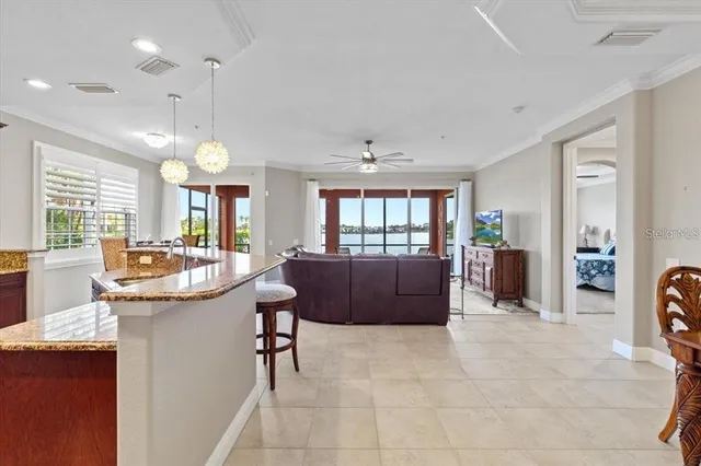 a living room with furniture a dining table and a large window