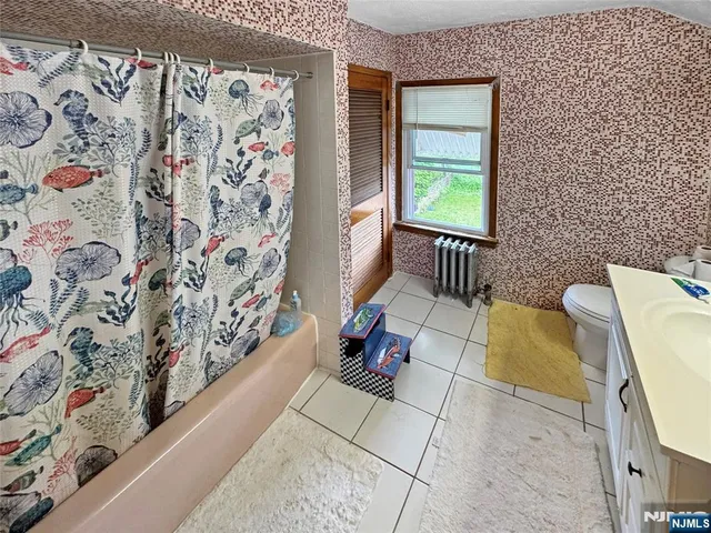 a bedroom with furniture and a dresser