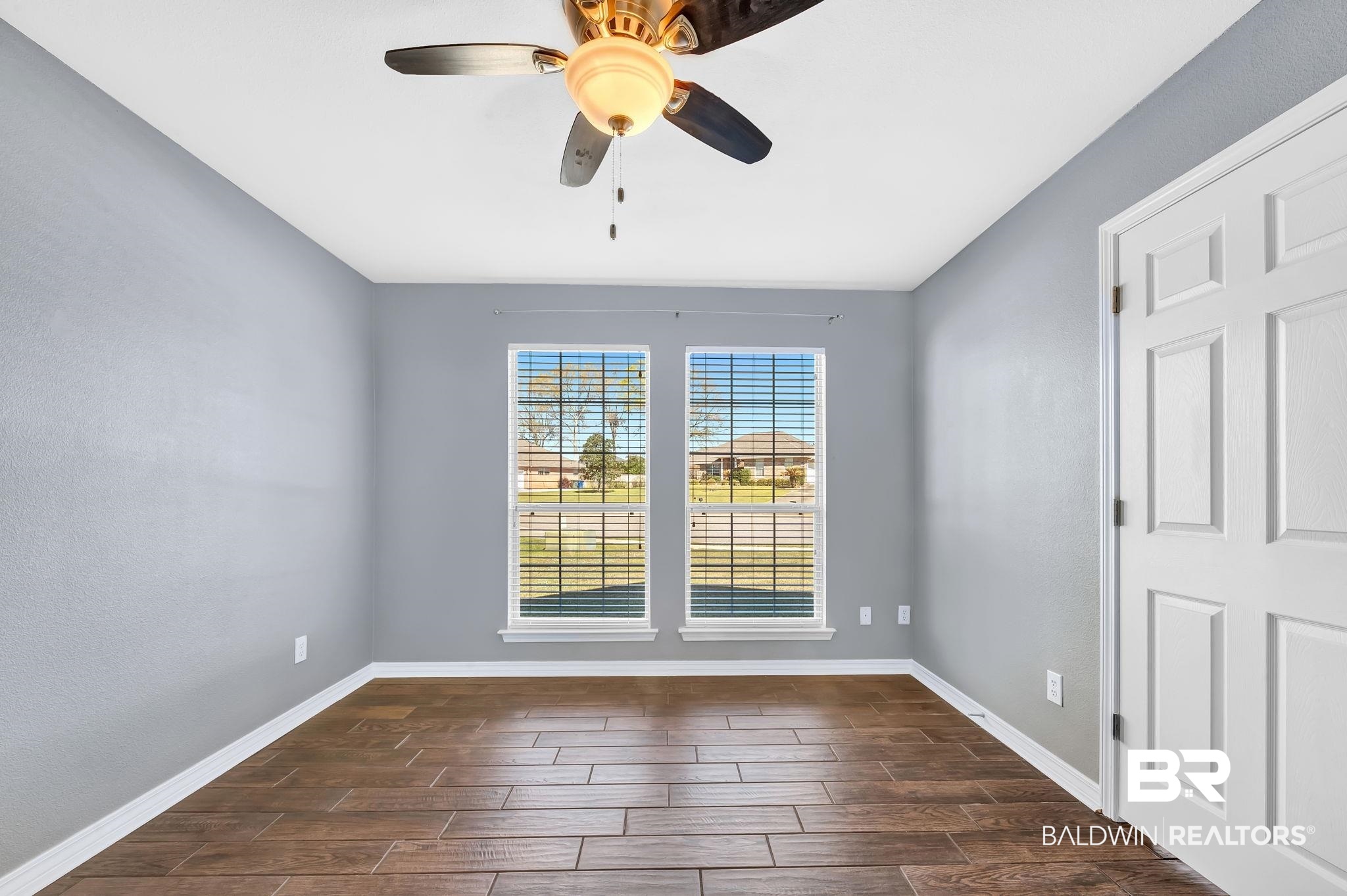 16444 Hamlet Lane Foley, AL 36535 - Photo 33 of 49 Unfurnished room featuring wood tiled floor, baseboards, and a ceiling fan