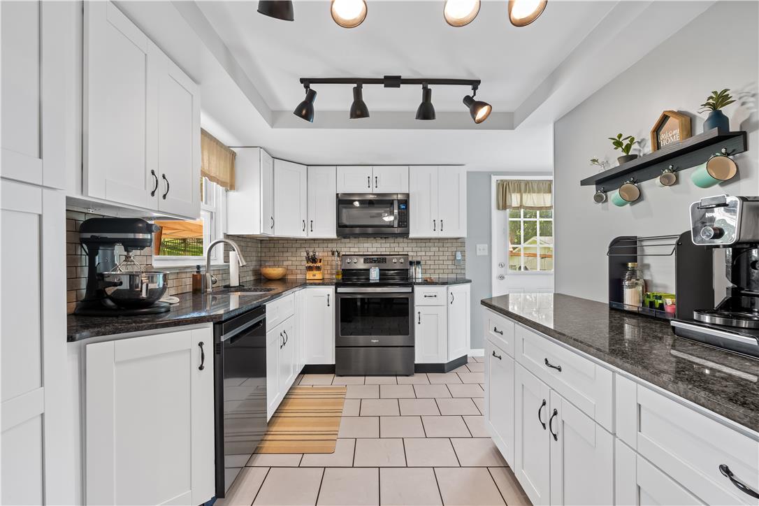 50 Kohls Road Northampton, PA 18067 - Photo 7 of 54 A well-appointed kitchen showcasing contemporary white cabinetry and sleek granite countertops, perfect for culinary adventures.
