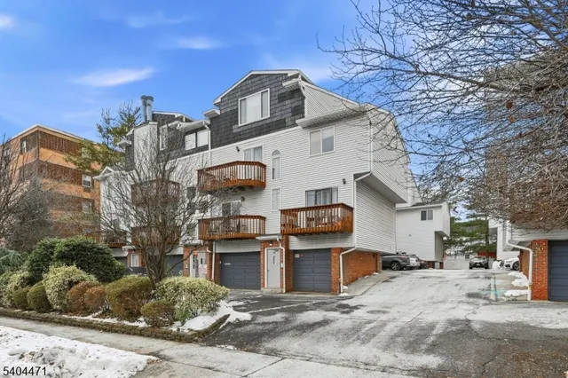 a kitchen with stainless steel appliances kitchen island granite countertop a refrigerator and a cabinets