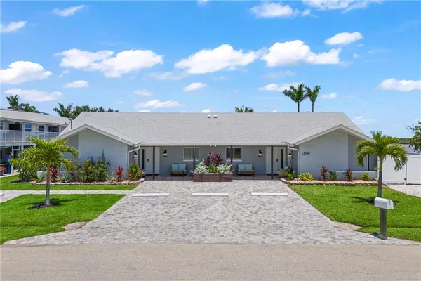 an aerial view of residential houses with outdoor space and ocean view