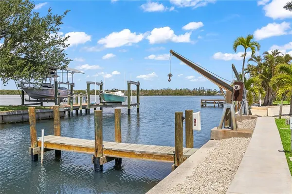 a living room with furniture a couch and paintings on the wall