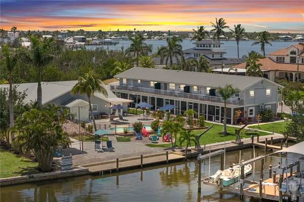 an aerial view of a house with a garden and lake view