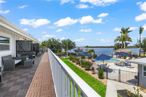 a view of a patio with dining table and chairs