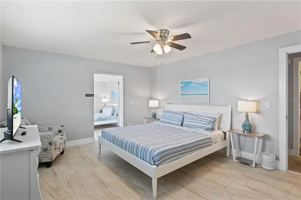 a view of a white house with a swimming pool and a fire pit