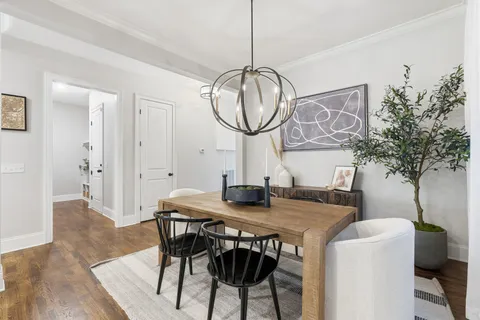 a living room with furniture kitchen and a large window