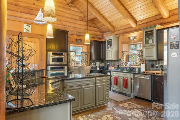 a kitchen with stainless steel appliances granite countertop a sink and cabinets