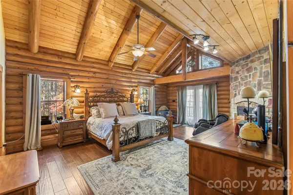 a bed sitting in a spacious bedroom next to a window