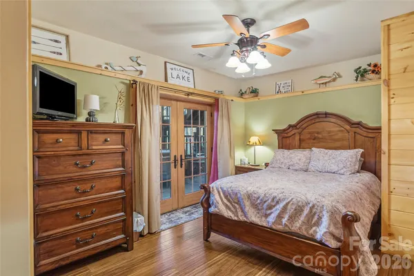 a bedroom with a bed and a chandelier