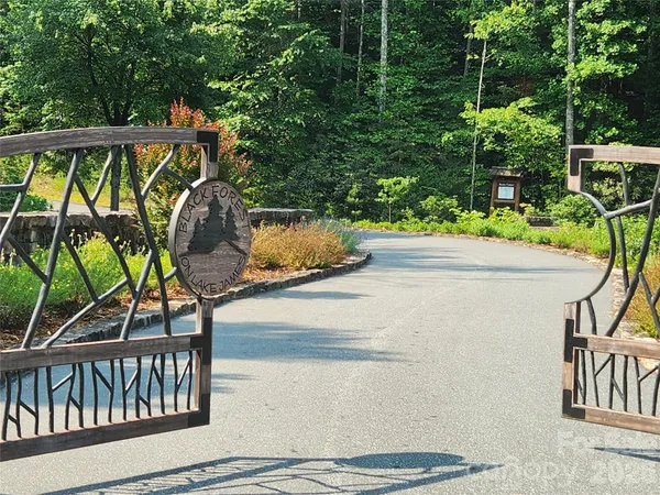 a view of backyard with a table and chairs under an umbrella
