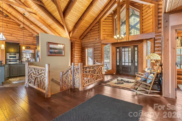 a hallway with a white stove top oven and couches with wooden floor