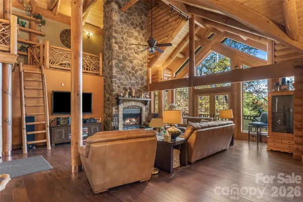 a living room with fireplace furniture and a large window