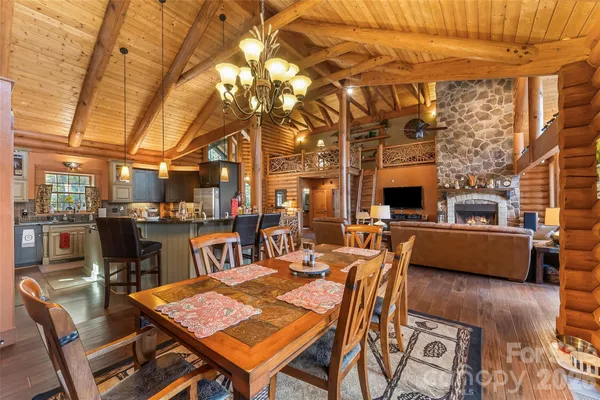 a view of a patio with dining table and chairs with wooden floor and fence