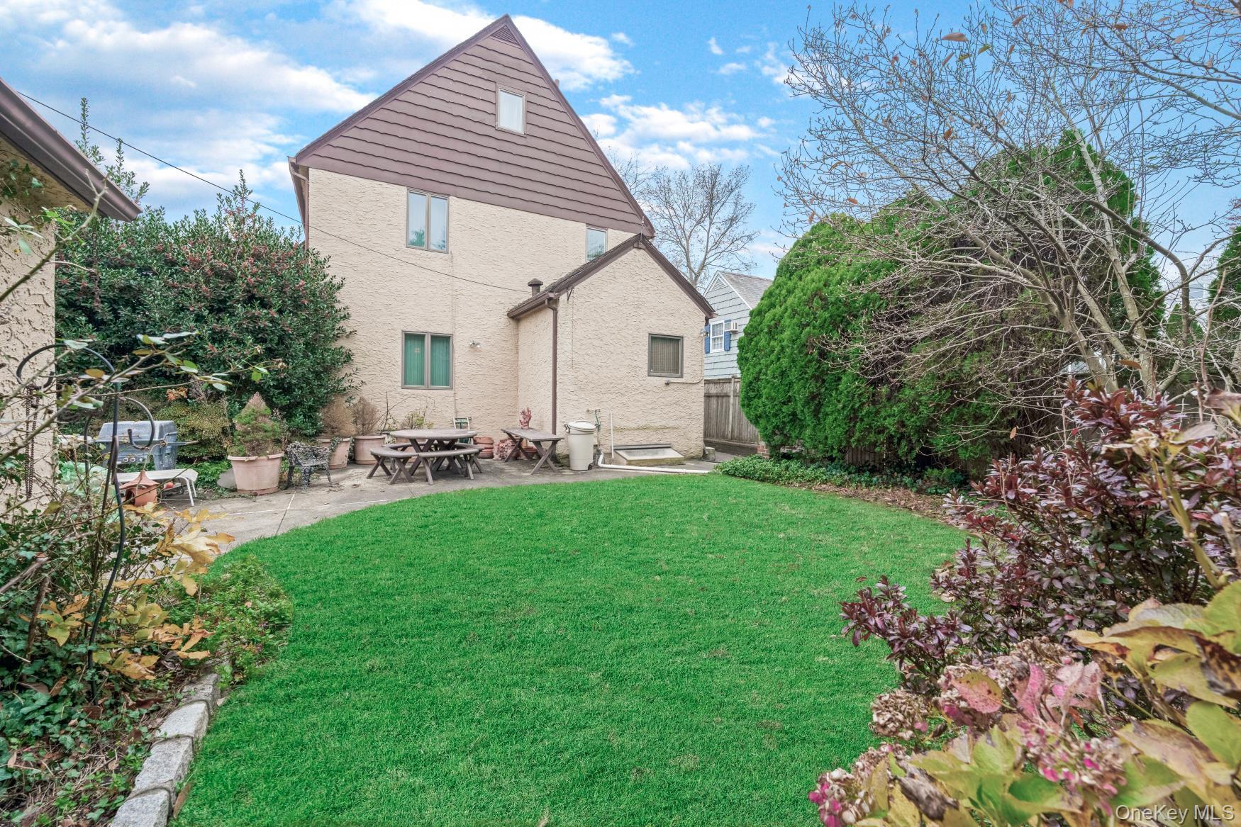 331 Richmond Road Queens, NY 11363 - Photo 4 of 26 a front view of house with a garden and patio