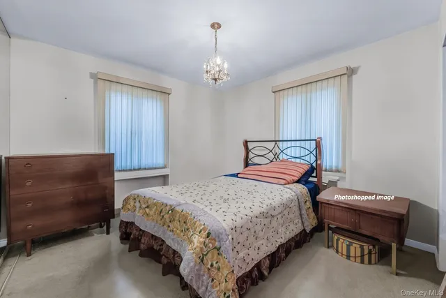 a bedroom with a bed wooden floor and window