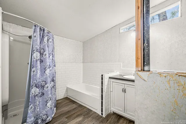 a bathroom with a bathtub and shower