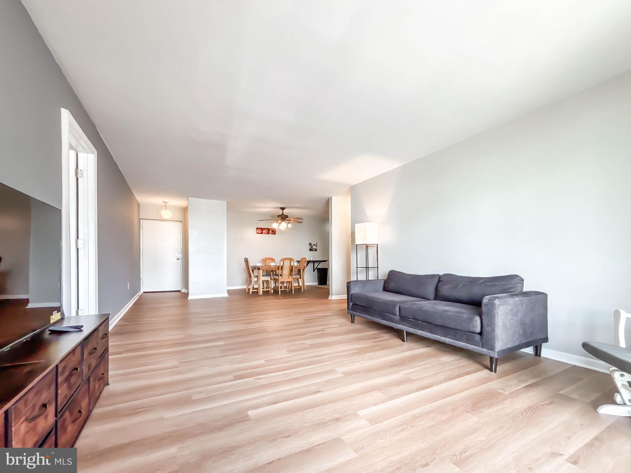 130 Slade Avenue, Unit 414 Baltimore, MD 21208 - Photo 7 of 48 a living room with furniture and a wooden floor